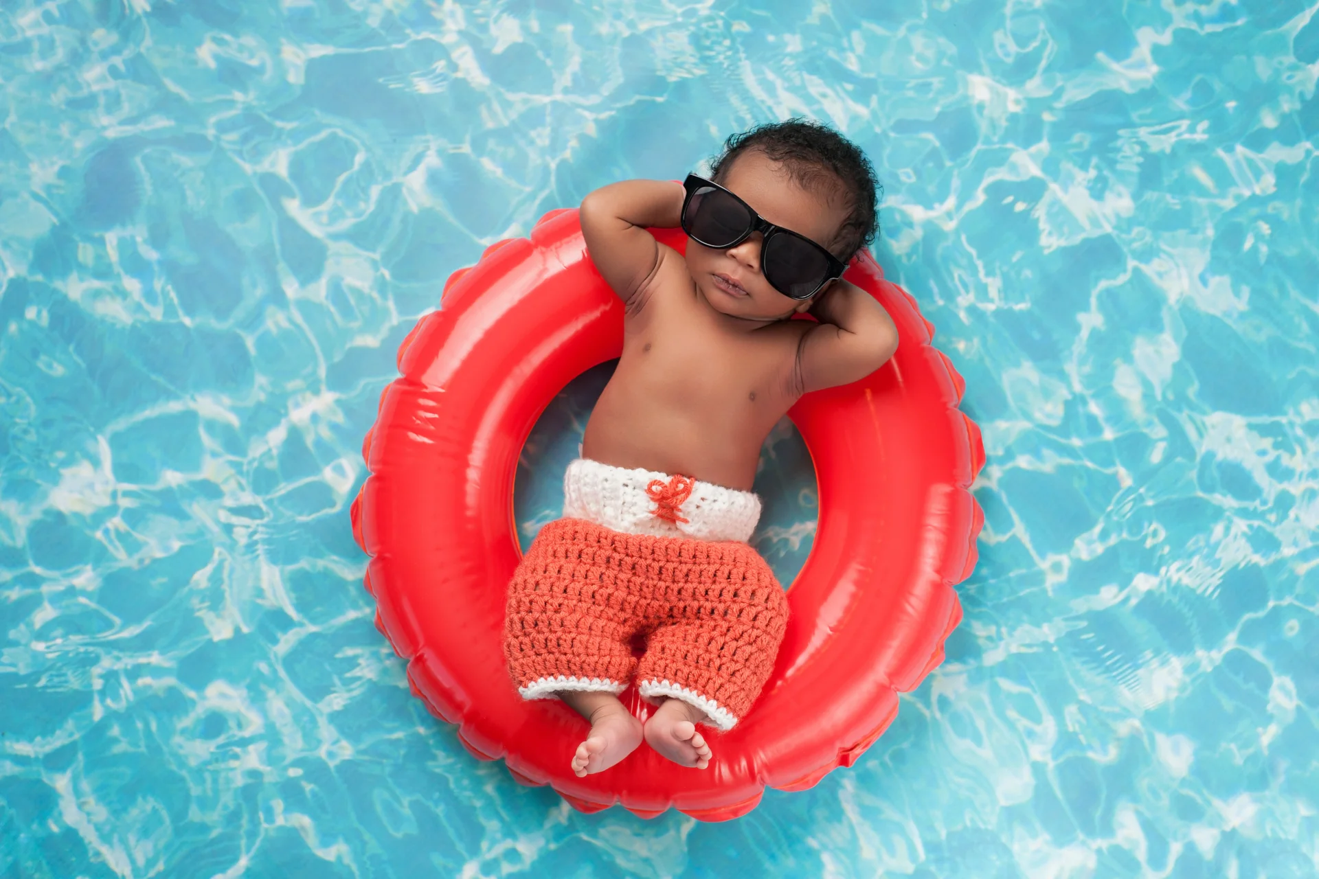 Child floating in pool with inner tube