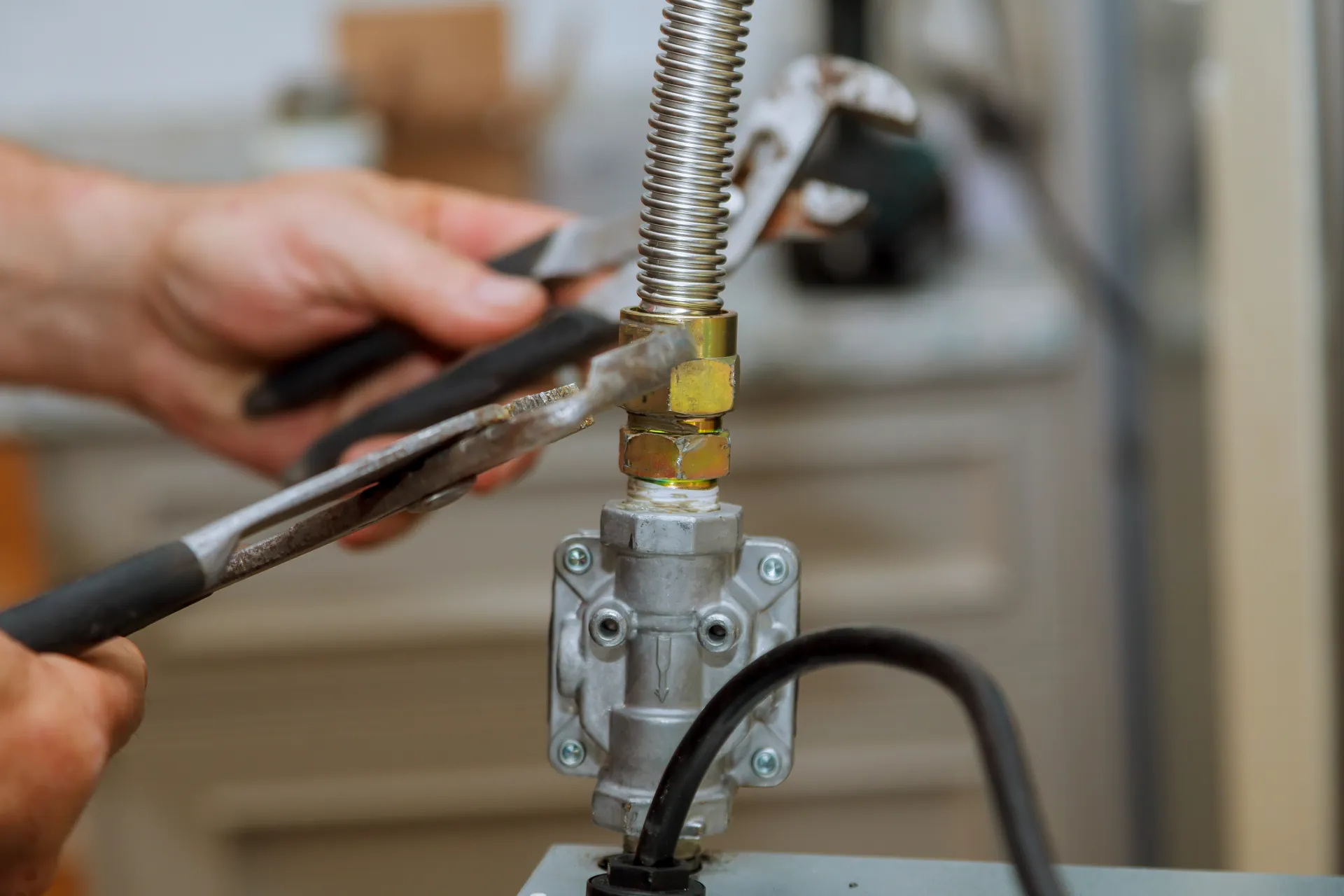 Technician adjusting nut on gas line